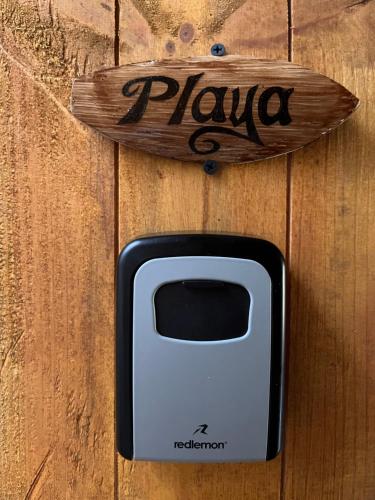 a black and white phone sitting on a wooden door at Blue House in Puerto Escondido