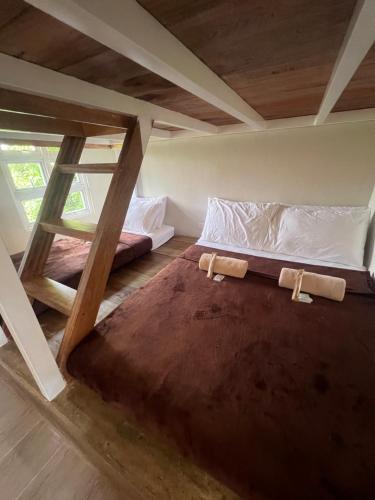a bedroom with two bunk beds in a attic at Balay na Bato in Legazpi