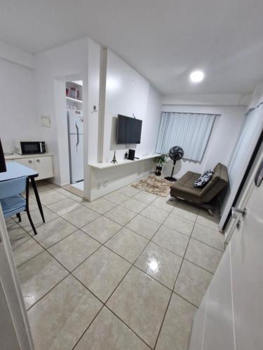 a living room with a couch and a tv in it at Apartamento em Maceió a beira mar in Maceió