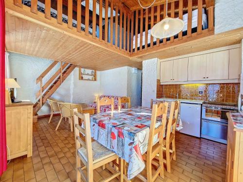 une cuisine avec une table et des chaises dans une pièce dans l'établissement Duplex cosy à La Clusaz pour 5 pers, animaux admis - FR-1-818-61, à La Clusaz