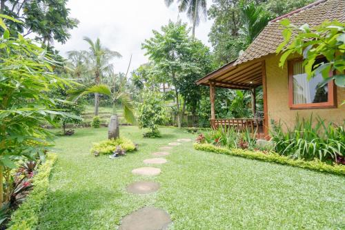 a garden in front of a house at Nishiyama House Sambangan by The Lavana in Ambengan