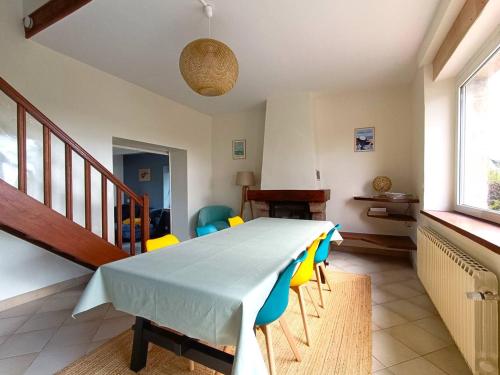 une salle à manger avec une table et quelques chaises dans l'établissement Maison moderne sur l'île avec jardin et Wi-Fi, proche plage - FR-1-368-450, à Pleumeur-Bodou