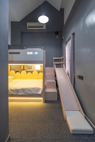 a bedroom with a bunk bed and a staircase at Rest Chinatown Hotel in Singapore