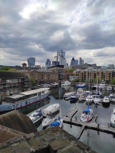 a group of boats docked in a harbor with buildings at Amazing location 1 BD flat on St Katharine's Docks in London