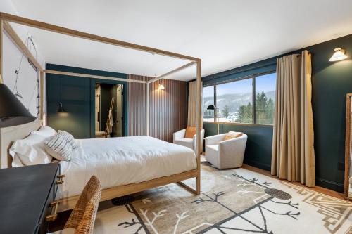 a bedroom with a large bed and a desk and chair at Inn At Mount Snow in West Dover