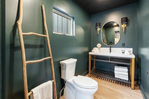 a bathroom with a white toilet and a sink at Inn At Mount Snow in West Dover