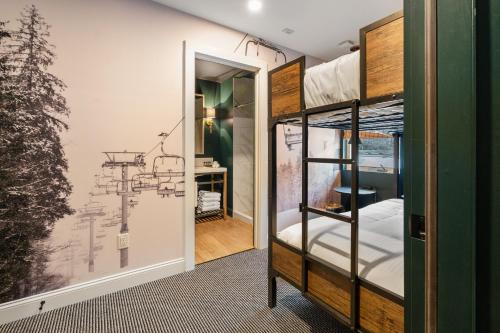 a room with bunk beds and a hallway at Inn At Mount Snow in West Dover
