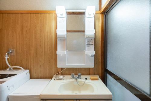 a small kitchen with a sink and a microwave at Kujukuri Town Katakai Detached House in Katakai