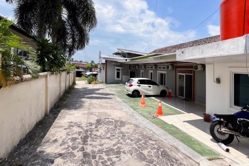 a car parked in front of a house at Kostel 99 Pangkal Pinang RedPartner in Pangkalpinang