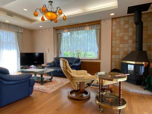a living room filled with furniture and a fireplace at Atami Venus in Atami