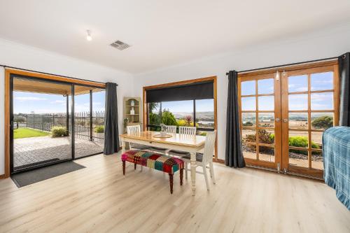 a living room with a table and chairs and sliding glass doors at The Heights in Mannum