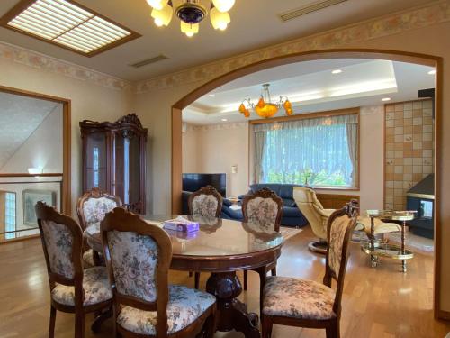 a living room with a table and chairs at Atami Venus in Atami