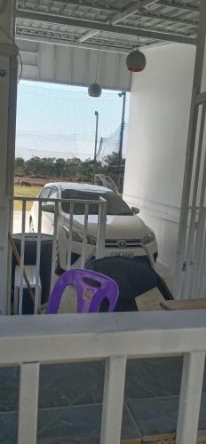 a car parked in a parking lot with purple chairs at VicaWorld in Prathai