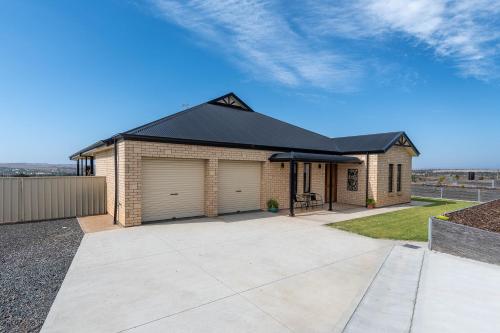 a house with a garage with a black roof at The Heights in Mannum