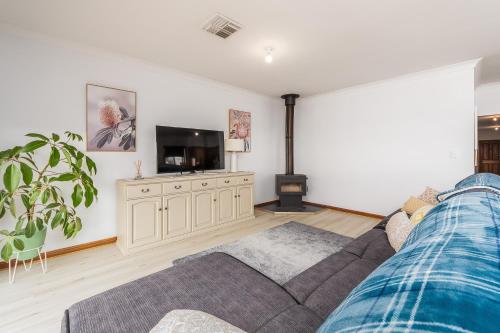 a living room with a couch and a flat screen tv at The Heights in Mannum