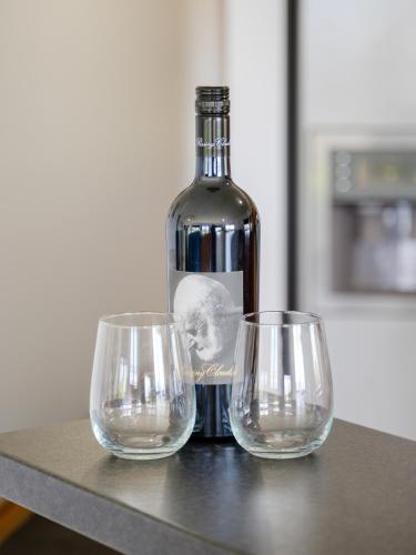 a bottle of wine and two wine glasses on a table at The Heights in Mannum