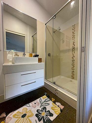 a bathroom with a sink and a shower at Pantai Indah Villa in Torquay