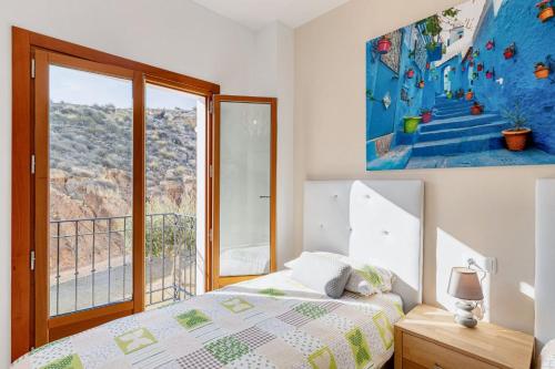 a bedroom with a bed and a large window at Spacious apartment with pool in the heart of Murcia - 128 m² in Murcia