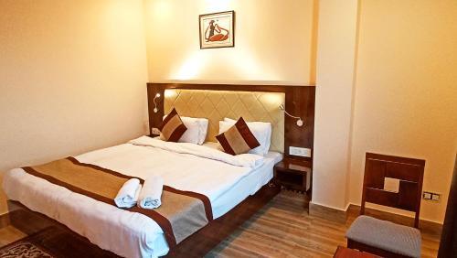a hotel room with a large bed in a room at Garden Retreat Hotel in Gangtok