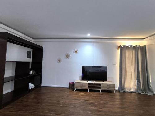 a living room with a flat screen tv at U Story Resort in Siquijor