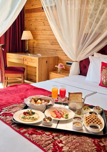 a tray of food on a bed in a hotel room at Deventure Shimla Hills in Kandāghāt