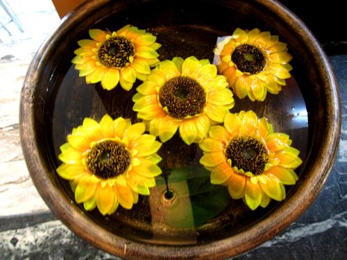 a group of yellow flowers in a bowl at Garden Retreat Hotel in Gangtok