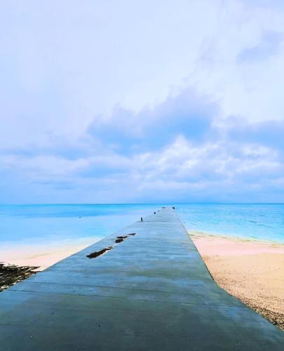 a long pier stretches out into the ocean at Maison Paradis -Taketomi Island- メゾンパラディ竹富島 in Taketomi