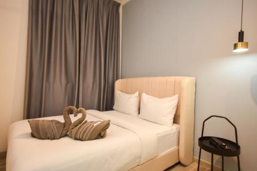 a bedroom with a bed with two stuffed animals on it at Midvalley Southkey Mosaic Suite by Nest Home in Johor Bahru