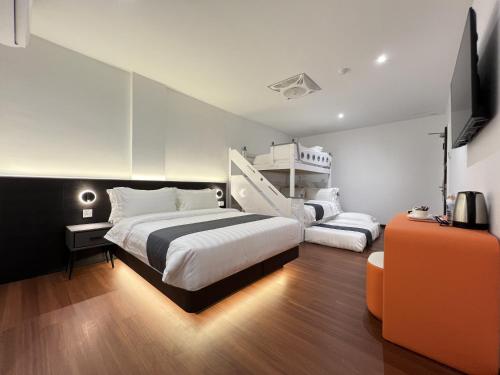a bedroom with two beds and a bunk bed at Asia Premium Hotel Kuala Terengganu in Kuala Terengganu