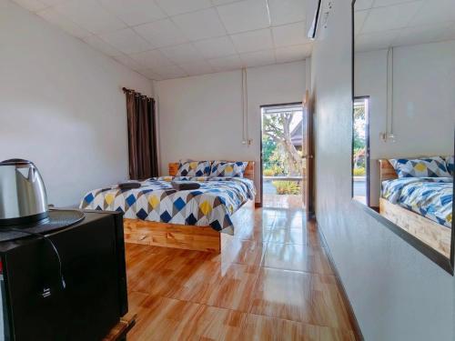 Ένα ή περισσότερα κρεβάτια σε δωμάτιο στο Oonrak Resort อุ่นรักรีสอร์ท ที่พัก อำเภอบ้านผือ จังหวัดอุดรธานี