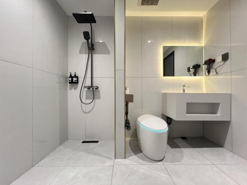 a bathroom with a shower and a toilet and a sink at Asia Premium Hotel Kuala Terengganu in Kuala Terengganu