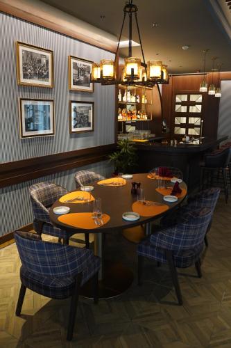 a dining room with a table and chairs at Courtyard by Marriott Bhopal in Bhopal