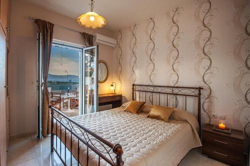 a bedroom with a bed and a view of the ocean at Nereid Villa, summer feeling, By ThinkVilla in Episkopí- Rethimno
