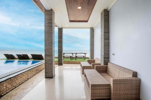 a view of the ocean from the balcony of a house at Barton Beach Inn in Nusa Penida
