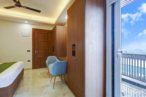 a bedroom with a bed and a desk and a window at Limewood Stay Premium Studios - Near Sector 29 in Gurgaon