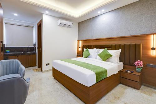 a hotel room with a bed and a chair at Limewood Stay Premium Studios - Near Sector 29 in Gurgaon