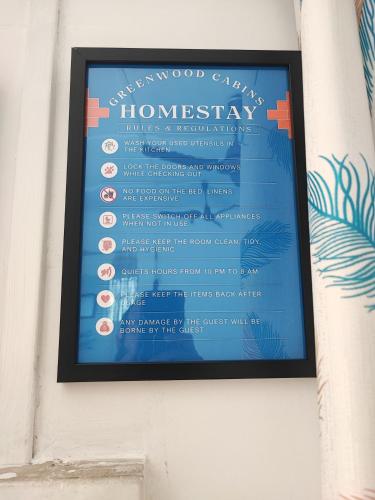 a picture of a sign on a wall at Greenwood Cabins Homestay, The Greenhouse in Jorhāt