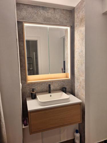 a bathroom with a sink and a mirror at Smarthome Suites Centro Storico Collegno in Collegno
