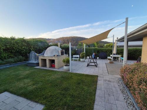 a backyard with a fire pit and a tent at Orford Coastal Retreat by Peppy Beach Retreats in Orford