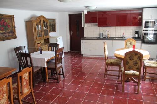 a kitchen and dining room with a table and chairs at Diófa Vendégház in Bükkszék