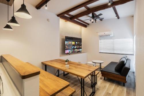 a kitchen and dining room with a wooden table and chairs at WONDERDREAM STAY KASHIWA with Free parking in Kashiwa