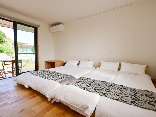 Katil atau katil-katil dalam bilik di 石垣島 villa 7716