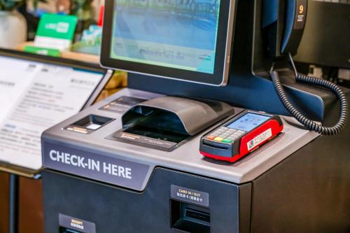 a cash register with a computer on top of it at CHECK inn Express Taichung Fengchia in Taichung
