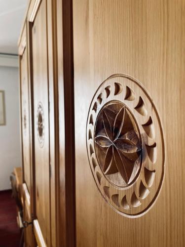 a wooden door with a circular design on it at Hotel Bernina in Pontresina