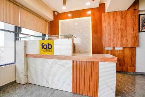 a fast food restaurant with a yellow sign on a counter at FabHotel SR Naroda - Nr Akshardham in Ahmedabad
