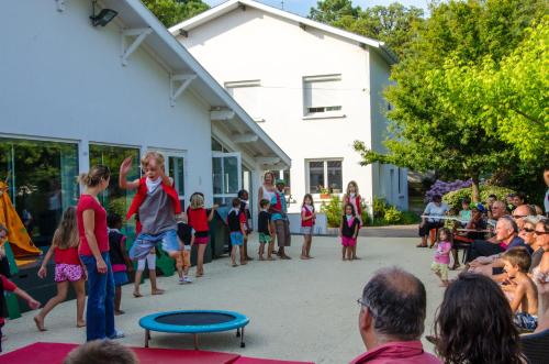 a group of children standing around in front of a crowd at Cap Océan in Seignosse