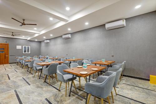 a conference room with wooden tables and chairs at Limewood Stay Premium Studios - Near Sector 29 in Gurgaon