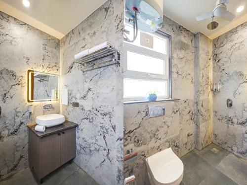 a bathroom with a toilet and a sink and a window at Limewood Stay Premium Studios - Near Sector 29 in Gurgaon