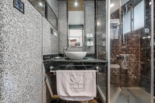 a bathroom with a sink and a glass shower at CHECK inn Express Taichung Fengchia in Taichung