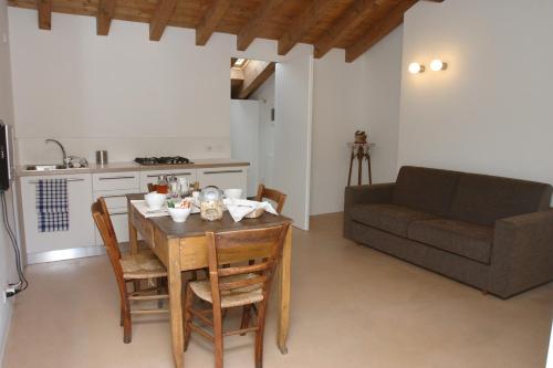 a living room with a table and a couch at Casa Ester in Feltre